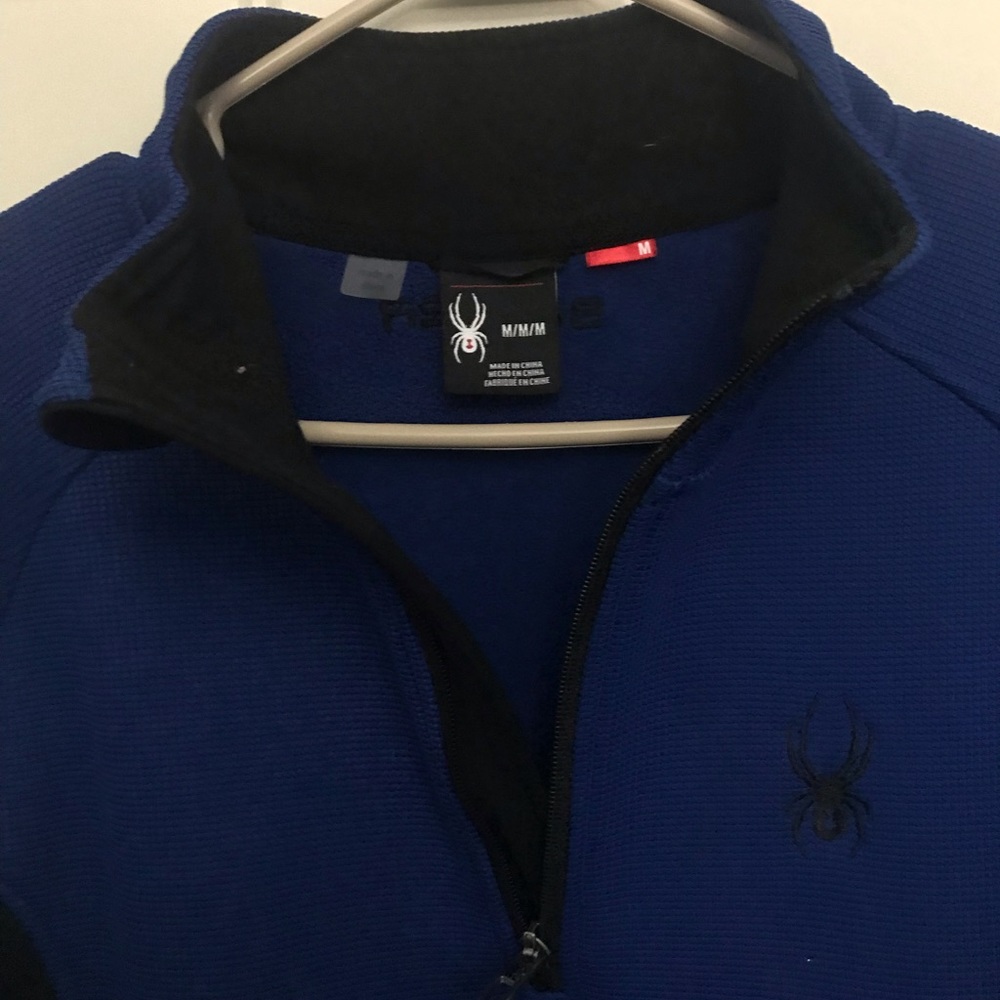 Spider blue and black half zipper sweater.